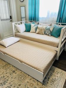 2 łóżka z poduszkami w pokoju w obiekcie Coastal Chic Suite with Kitchenette and Private Entrance w mieście Saint Petersburg