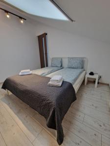 a bedroom with a bed with two towels on it at Key Apartments in Main Square in Braşov
