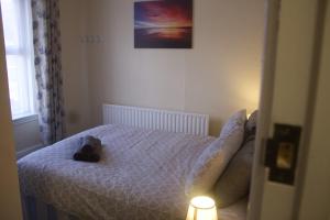 a bedroom with a bed with a stuffed animal on it at Elm Tree Guest House in Weston-super-Mare