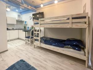 two bunk beds in a room with a kitchen at Solne Apartamenty Luna in Wieliczka +7 photos