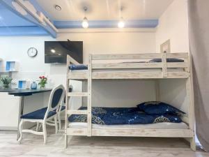 a bunk bed in a room with a desk at Solne Apartamenty Luna in Wieliczka