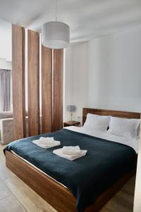 a bedroom with a large bed with two towels on it at PS Apartments in Ohrid