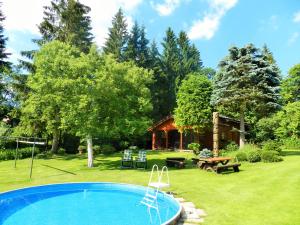 a swimming pool in a yard with a house at Chalupa U Beranů in Harrachov