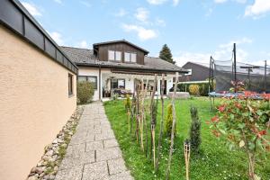 a house with a stone pathway in front of a yard at Sali Homes - SchaefersNest in Obersulm