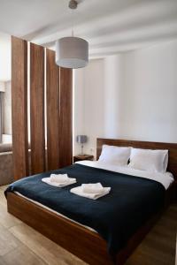 a bedroom with a large bed with two towels on it at PS Apartments in Ohrid