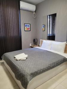 a bedroom with a bed with a towel on it at Studio M in Plovdiv