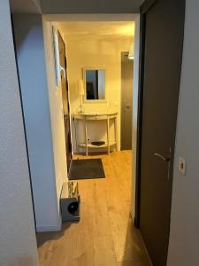 a hallway with a room with a table and a mirror at Chambres d'hôtes Marylou in Valensole