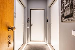 a hallway with an open door with a floor at City Life House-YELLOW San Siro & Duomo in Milan