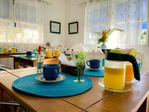 a table with two plates and a pitcher of orange juice at A Primeira Vista in Florianópolis