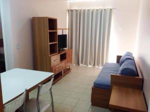 a living room with a bed and a dining room table at Apartamento Serra Park in Rio Quente +10 photos