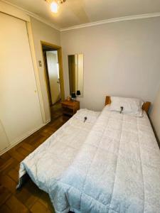 1 dormitorio con 1 cama blanca grande en una habitación en Guest House GAAM Las Condes, en Santiago