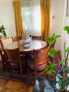 a dining table and chairs in a room with a table and a window at Guest House GAAM Las Condes in Santiago