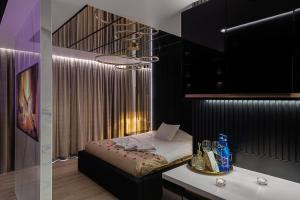 a bedroom with a bed and a table with a counter at Wiślane Tarasy VIP Apartamenty JACUZZI in Krakow +17 photos