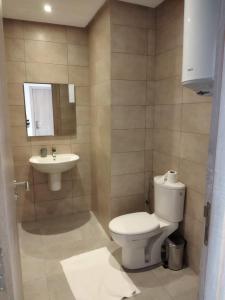 a bathroom with a toilet and a sink at COSTA MAR MARTIL TETOUAN in Martil