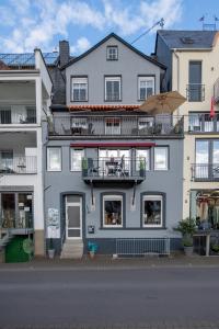 a large blue building with a balcony at Haus Moselwelt - Tilda in Zell an der Mosel