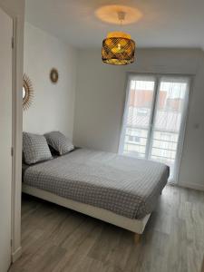 Ένα ή περισσότερα κρεβάτια σε δωμάτιο στο La maison des dunes