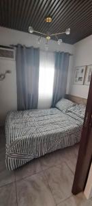 Una cama o camas en una habitación de Amaia Cabanatuan Block 21 Lot 14 Unit B