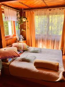 una camera da letto con letto, cuscini e finestra di Pokoje gościnne u Ewy a Zakopane