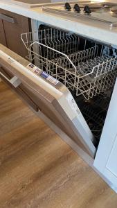 a dishwasher with a white dish rack in it at Il Girasole in Peschiera del Garda +20 photos
