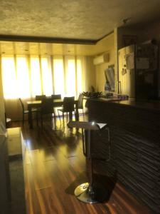 a dining room with tables and chairs and windows at Family View Sunset Apartment in Varna City