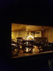 a dining room with a table and chairs and lights at 100SaulesVikingi in Grobiņa