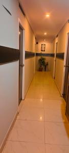 a hallway with a long corridor with a tile floor at CENTRAL GATE in Chennai