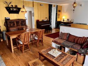 a living room with a table and a couch at Maison de charme Montreuil Proche Paris in Montreuil