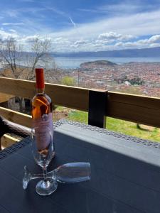 a bottle of wine sitting on top of a table at Villa & Apartments Cityview Ohrid in Ohrid