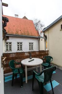 a patio with a table and chairs on a balcony at The Knight House in Tallinn