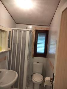 a small bathroom with a toilet and a sink at limone in Carloforte