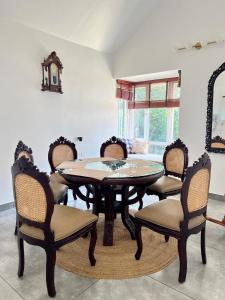 a dining room with a table and chairs at The Heyday in Vagamon