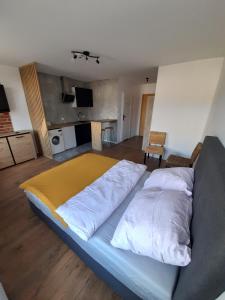 duże łóżko w pokoju z kuchnią w obiekcie Pokoje Gościnne FABIO w mieście Chojnice