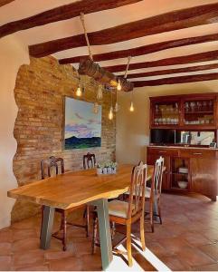 comedor con mesa de madera y sillas en Casa Rural Cal Casetó en Font-Rubí