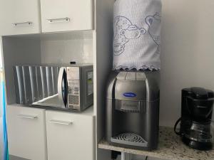 uma cozinha com um micro-ondas e comodidades para preparar café em Apartamento 03B Residencial Morada do Vale em Garanhuns
