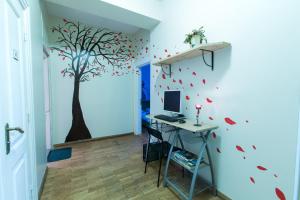 a home office with a tree mural on the wall at The Knight House in Tallinn