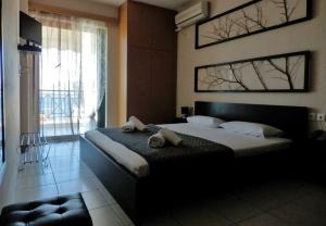 a bedroom with a bed with two towels on it at Sagini Boutique Hotel in Loutra Edipsou