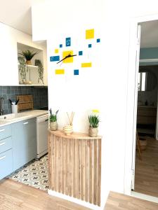 a kitchen with a counter with plants on a wall at Cocon cosy hypercentre bordeaux in Bordeaux