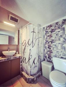 a bathroom with a white toilet and a sink at Tararas apartments in Nea Michaniona +36 photos