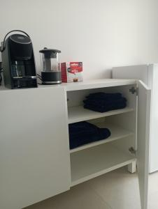a white counter with a coffee maker on it at Sea & Country Rooms in Golfo Aranci