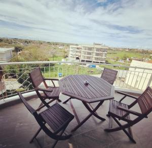 a table and chairs on a balcony with a view at Tararas apartments in Nea Michaniona
