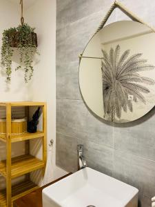 a bathroom with a mirror and a sink at Boogalow Hostel in Gijón