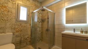 a bathroom with a shower and a sink at Farm House in Vlachata +14 photos
