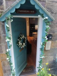 a blue door with a wreath on it at Darnholm Cottage in Robin Hood's Bay