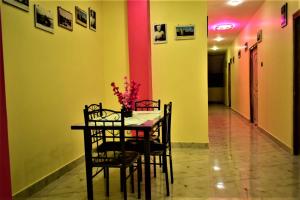 a dining room with a table and chairs in a hallway at Andaman Runway in Port Blair