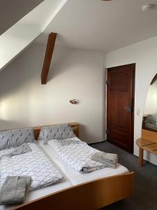 a bedroom with two beds and a staircase at Landgasthof zum SEEHOF in Rottweil