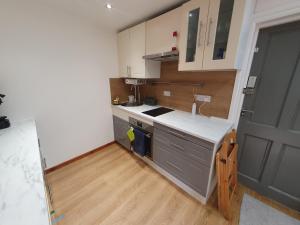 a kitchen with a sink and a counter top at Studio apartment, TV, WiFi Kitchen Parking, Wembley Elizabeth Line in Northolt