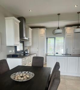 a kitchen with a table with a bowl of food on it at Contemporary Townhouse Stunning lakeside location in Belturbet
