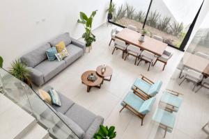 a living room with a couch and a table and chairs at Casa con Vista al Cielo in Aguascalientes