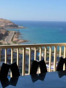a table on a balcony with a view of the ocean at Penthouse 5 bedrooms at Porto Sokna pyramids Family only in Ain Sokhna