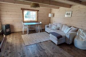 a living room with a couch and a table at Leeotsa Talu Ait 